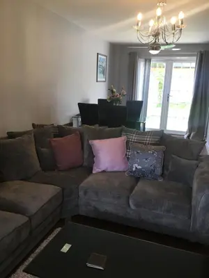 a living room with a couch with pillows on it at Villa Belle Three bedrooms Basildon in Basildon
