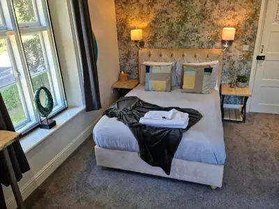 a bedroom with a bed with towels on it at CopperBeech Bed and Breakfast in Yoxford