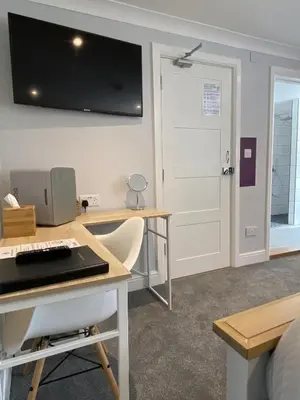 a room with a desk with a computer and a door at CopperBeech Bed and Breakfast in Yoxford