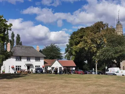 a white house with a group of people in front of it at The Cavendish Five Bells in Cavendish