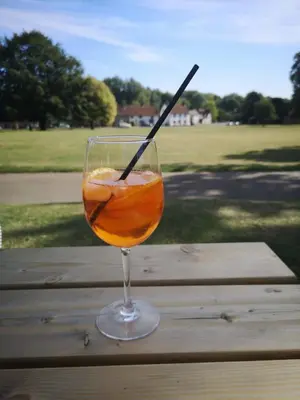 a drink in a glass sitting on a wooden table at The Cavendish Five Bells in Cavendish
