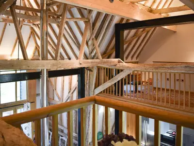 a view from the loft of a building with wooden beams at Ivy Todd Barn in Ashdon
