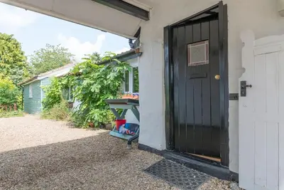 a door to the side of a house at Cobweb Cottage Studios in Spooner Row