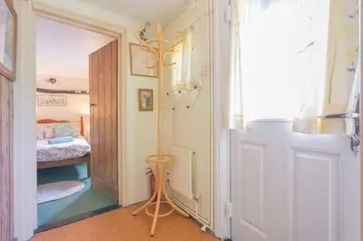 a hallway with a door leading to a bedroom at Cobweb Cottage Studios in Spooner Row