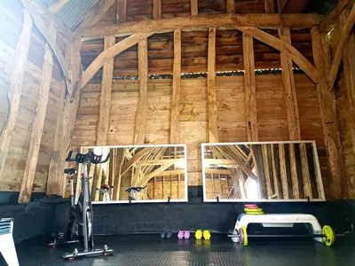 a room with a gym with a bike in it at Wingfield Escapes in Diss