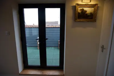 a door leading into a room with a window at Spacious Apartment with Roof Terrace, near The Waterfront, Ipswich in Ipswich