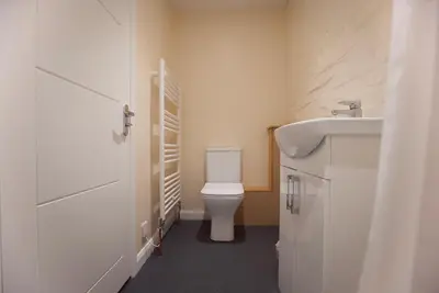a bathroom with a white toilet and a sink at Spacious Apartment with Roof Terrace, near The Waterfront, Ipswich in Ipswich
