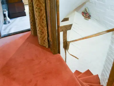 an orange rug on the floor next to a window at Tattlepot Farmhouse in Tivetshall Saint Margaret