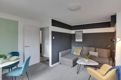 a living room with a couch and a table at George Suite - Central Location - Free Allocated Parking in Chelmsford