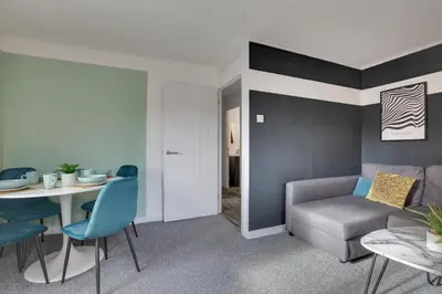 a living room with a couch and a table at George Suite - Central Location - Free Allocated Parking in Chelmsford