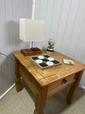 a wooden table with a lamp on top of it at The Stables & Silos in Braintree