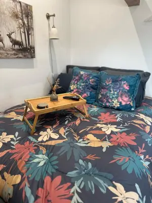 a bedroom with a bed with a table on it at The Stables & Silos in Braintree