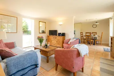a living room with two couches and a table at 2 Hazelwood - 2 bedroom house near Aldeburgh & Snape Maltings - Aldeburgh Coastal Cottages in Aldringham