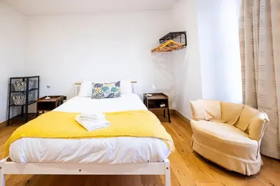 a bedroom with a bed and a chair at Three Tuns Apartments - Ash in Pettistree