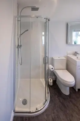 a bathroom with a shower with a toilet and a sink at Pigwig Cottage, Thorpeness in Thorpeness