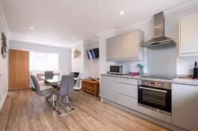 a kitchen and dining room with a table and chairs at Pigwig Cottage, Thorpeness in Thorpeness