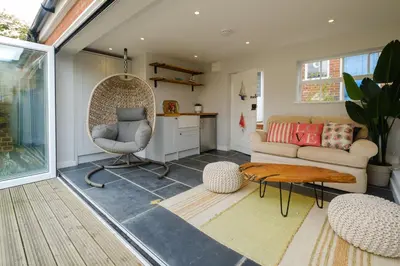 a living room with a couch and a chair at Elm Cottage in Aldeburgh