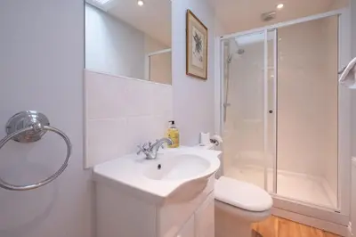 a bathroom with a sink and a shower and a toilet at 4 Wards Place in Aldeburgh