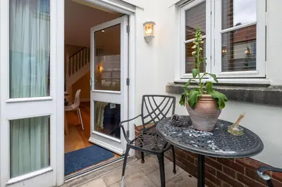 a table with a potted plant on a patio at 4 Wards Place in Aldeburgh