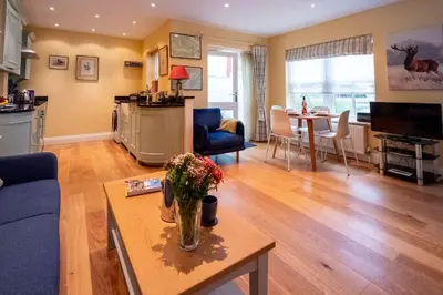a living room with a vase of flowers on a table at 4 Wards Place in Aldeburgh