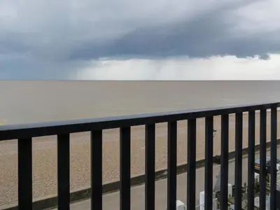 a view of the beach from a balcony at Gunfleet, Aldeburgh - A Large Seafront House with Stunning Sea Views from all the floors, Sleeps 14 - Aldeburgh Coastal Cottages in Aldeburgh