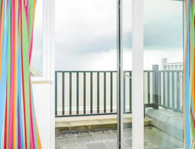 a window with a view of a balcony at Gunfleet, Aldeburgh - A Large Seafront House with Stunning Sea Views from all the floors, Sleeps 14 - Aldeburgh Coastal Cottages in Aldeburgh