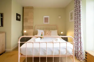a bedroom with a white bed with towels on it at The Tower in Thorpeness