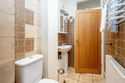 a bathroom with a toilet and a sink at The Tower in Thorpeness