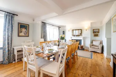 a dining room with a table and chairs at Sea View, Thorpeness in Thorpeness