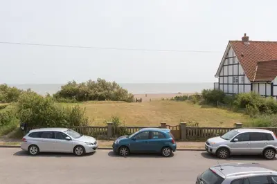 three cars parked in a parking lot near the beach at Sea View, Thorpeness in Thorpeness