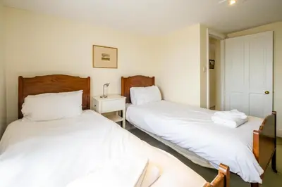 two beds sitting next to each other in a bedroom at Sea View, Thorpeness in Thorpeness