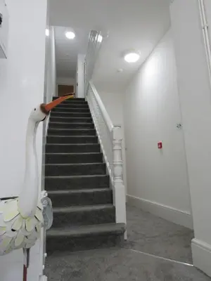 a staircase in a building with a swan on the railing at The Tas Suites - Tas Accommodations in Cambridge
