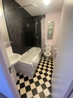 a bathroom with a tub and a sink and a toilet at WynnStay Studio Apartments in Southend-on-Sea