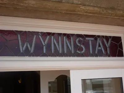 a window over a door with the winning sign on it at WynnStay Studio Apartments in Southend-on-Sea
