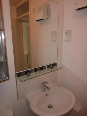 a bathroom with a sink and a mirror at WynnStay Studio Apartments in Southend-on-Sea