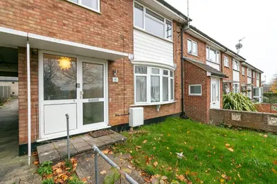 a brick house with a white door at Denby Lodge in Letchworth