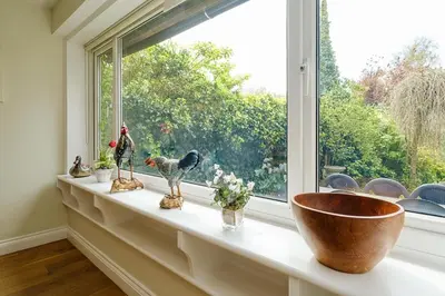 a window sill with a bowl and birds on it at Turret House, Thorpeness - Close to the beach, Thorpeness Lake , Thorpeness Hotel, Golf and Country Club - Aldeburgh Coastal Cottages in Thorpeness