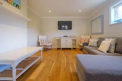 a living room with a couch and a table at Turret House, Thorpeness - Close to the beach, Thorpeness Lake , Thorpeness Hotel, Golf and Country Club - Aldeburgh Coastal Cottages in Thorpeness