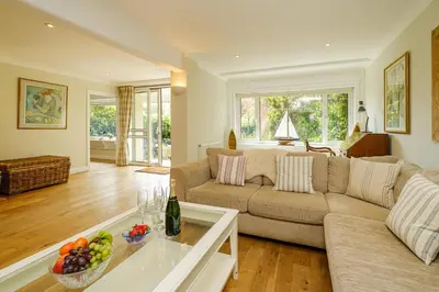 a living room with a couch and a table at Turret House, Thorpeness - Close to the beach, Thorpeness Lake , Thorpeness Hotel, Golf and Country Club - Aldeburgh Coastal Cottages in Thorpeness