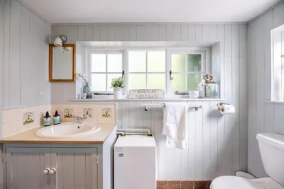 a bathroom with a sink and a toilet at Margo's Cottage, Orford in Orford