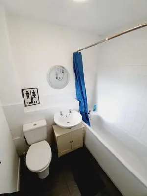 a bathroom with a toilet and a sink and a tub at 2 Bedroom Rayleigh Apartment in Rayleigh