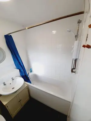 a bathroom with a sink and a bath tub at 2 Bedroom Rayleigh Apartment in Rayleigh