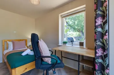 a bedroom with a desk and a bed and a window at Pass the Keys Charming and Central Garden Studio Flat Free Parking in Cambridge