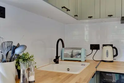 a kitchen counter with a sink and a toaster at Pass the Keys Charming and Central Garden Studio Flat Free Parking in Cambridge