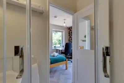 a room with a bed and a desk with a window at Pass the Keys Charming and Central Garden Studio Flat Free Parking in Cambridge