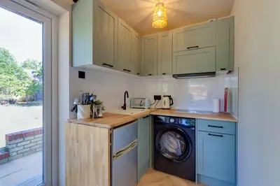 a kitchen with a washer and dryer next to a window at Pass the Keys Charming and Central Garden Studio Flat Free Parking in Cambridge