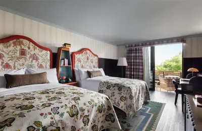 a hotel room with two beds and a balcony at Graduate by Hilton Cambridge in Cambridge