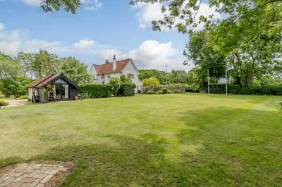 an image of a yard with a house at Garden Cottage in Diss