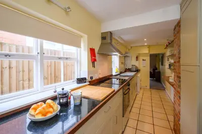 a kitchen with a bowl of oranges on the counter at 4 Old Homes, Thorpeness - Only a stones throw from the beach - Aldeburgh Coastal Cottages in Thorpeness
