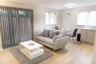 a living room with a couch and a table at Citystay Living - Hinton House in Cambridge